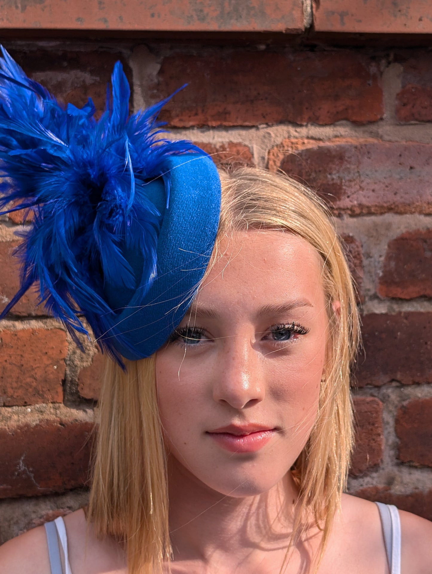 Royal blue pill box with feather accents fascinator